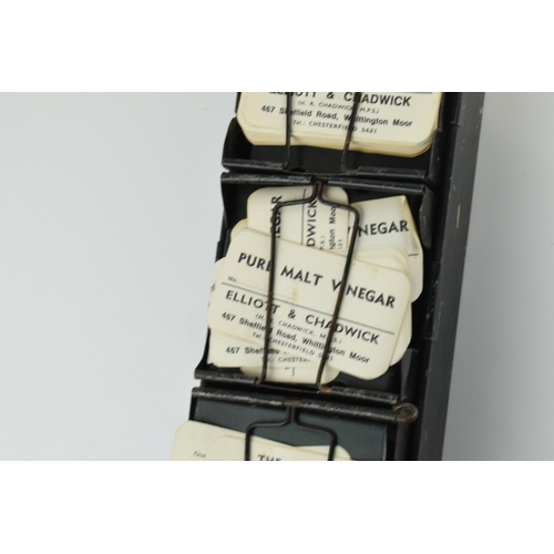 254 - 'The Alchemist Label Rack' with 6 sections for holding paper bottle labels, 43.5cm long, with some o... 