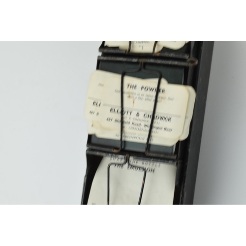 254 - 'The Alchemist Label Rack' with 6 sections for holding paper bottle labels, 43.5cm long, with some o... 