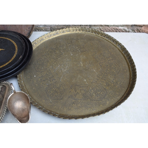 256 - A collection of Eastern copper and brass trays, largest 63cm diameter, some with incised decoration,... 