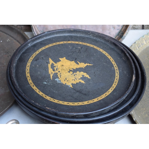 256 - A collection of Eastern copper and brass trays, largest 63cm diameter, some with incised decoration,... 