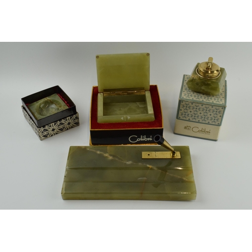 263 - Colibri: a collection of accessories in green onyx to include a table lighter, a pen stand, a trinke... 