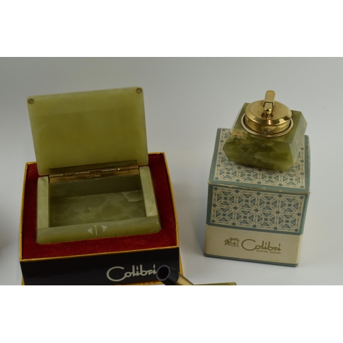 263 - Colibri: a collection of accessories in green onyx to include a table lighter, a pen stand, a trinke... 