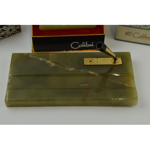 263 - Colibri: a collection of accessories in green onyx to include a table lighter, a pen stand, a trinke... 