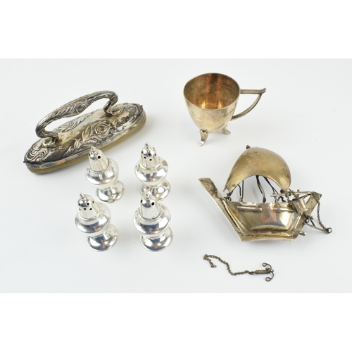 306 - A collection of silver items to include a nail buffer, a modernist style cup, a set of 4 loaded crue... 