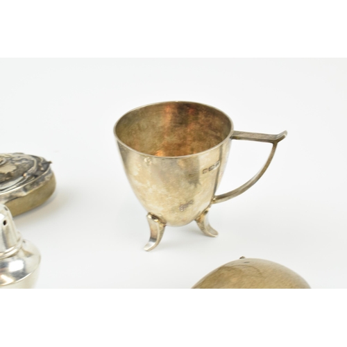 306 - A collection of silver items to include a nail buffer, a modernist style cup, a set of 4 loaded crue... 