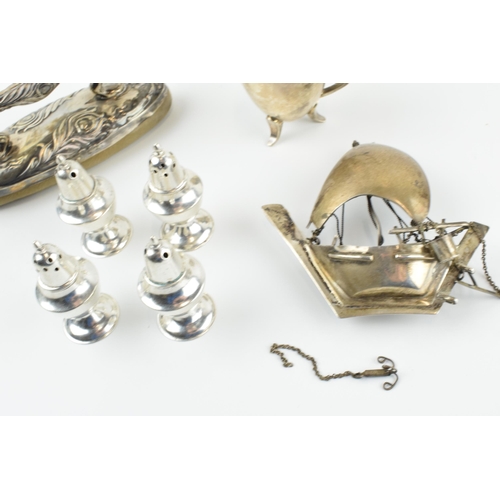 306 - A collection of silver items to include a nail buffer, a modernist style cup, a set of 4 loaded crue... 