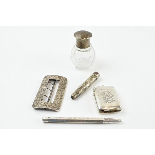 308 - Silver items to include a combination vesta case (hinge af), a belt buckle, a silver cased propellin... 