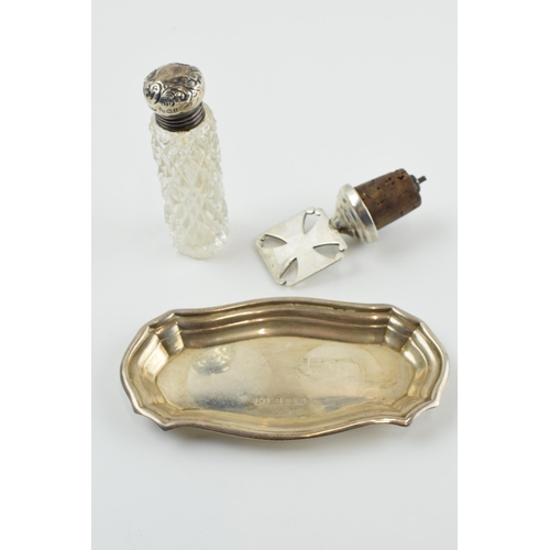 309 - A trio of silver items to include a silver shaped dish, 10cm long, 23.8 grams, a silver topped cut g... 