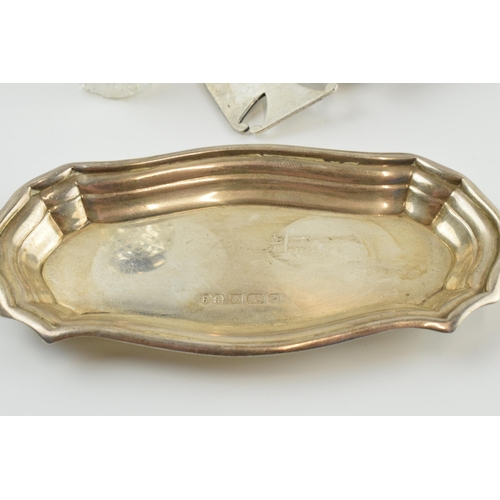 309 - A trio of silver items to include a silver shaped dish, 10cm long, 23.8 grams, a silver topped cut g... 