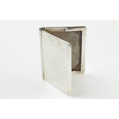 311 - Hallmarked silver novelty photo frame in the form of a book, 63 grams, Birmingham 1902, 6cm tall.