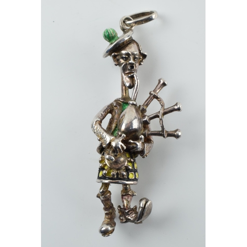 312 - Sterling silver figure / charm of a Scottish Bagpipe player with enamelled decoration, 31.0 grams, 7... 