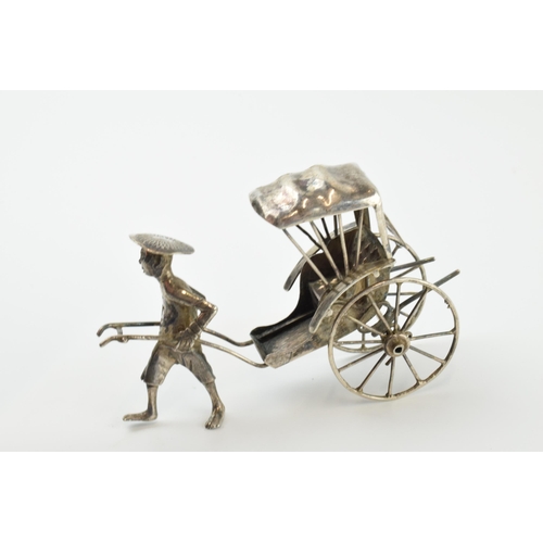 313 - A collection of novelty silver items to include a scene of a gentleman pulling a cart, a miniatures ... 