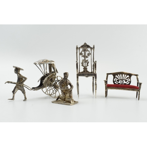 313 - A collection of novelty silver items to include a scene of a gentleman pulling a cart, a miniatures ... 