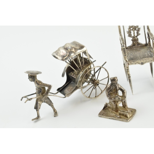 313 - A collection of novelty silver items to include a scene of a gentleman pulling a cart, a miniatures ... 