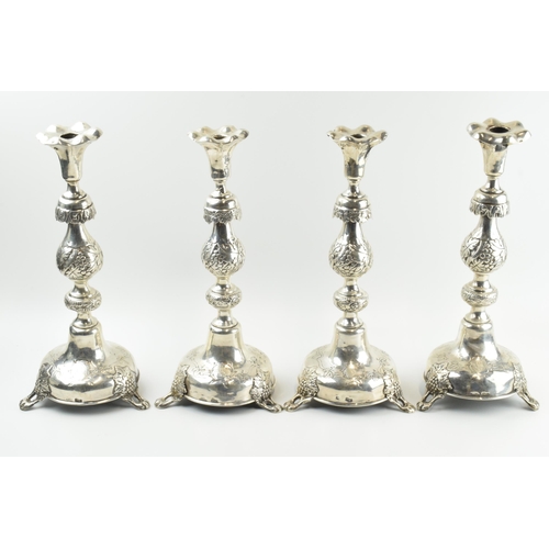 319 - A quartet of Russian silver ornate tall candlesticks, 34cm tall, with leaf and berry pattern decorat... 
