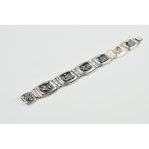 390 - 935 silver Chinese export silver panel link bracelet with dragon motifs, 33.7 grams, 20.5cm long.