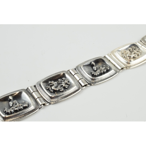 390 - 935 silver Chinese export silver panel link bracelet with dragon motifs, 33.7 grams, 20.5cm long.