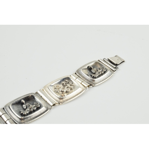 390 - 935 silver Chinese export silver panel link bracelet with dragon motifs, 33.7 grams, 20.5cm long.