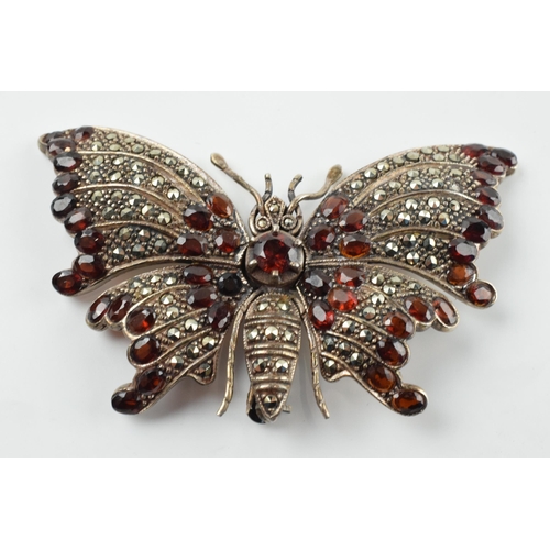 407 - Large sterling silver and marcasite articulated butterfly brooch set with garnets, 24.1 grams, 7cm w... 