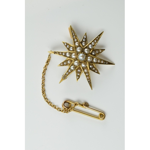 412 - 15ct gold star brooch set with seed pearls with safety chain, 5.0 grams.