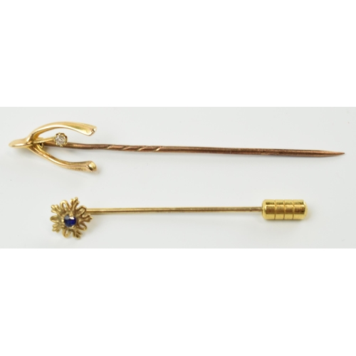 413 - A pair of 9ct gold stick pins, one with a diamond, the other a sapphire, metal pins, gross weight 1.... 