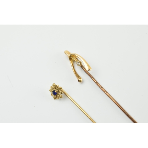 413 - A pair of 9ct gold stick pins, one with a diamond, the other a sapphire, metal pins, gross weight 1.... 