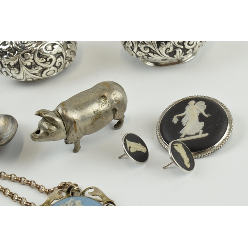 414 - Interesting items to include a novelty plated vesta case in the form of a pig, a pair of white metal... 