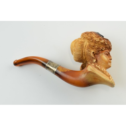 179 - Antique meerschaum pipe with amber mouthpiece and white metal collar, with carved decoration in the ... 