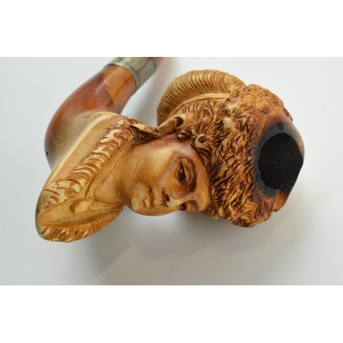 179 - Antique meerschaum pipe with amber mouthpiece and white metal collar, with carved decoration in the ... 