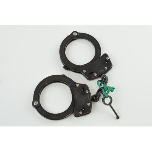 180 - A pair of Smith & Wesson handcuffs, M10 0-1, with key.