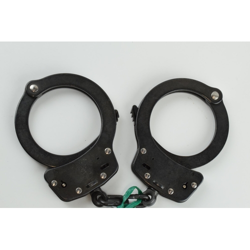 180 - A pair of Smith & Wesson handcuffs, M10 0-1, with key.