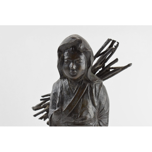 200 - Japanese influenced bronzed sculpture of a girl carrying sticks, 33cm tall.