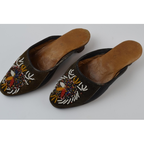 267 - A pair of Russian hand embroidered shoes with overlaid decoration, 25cm long.