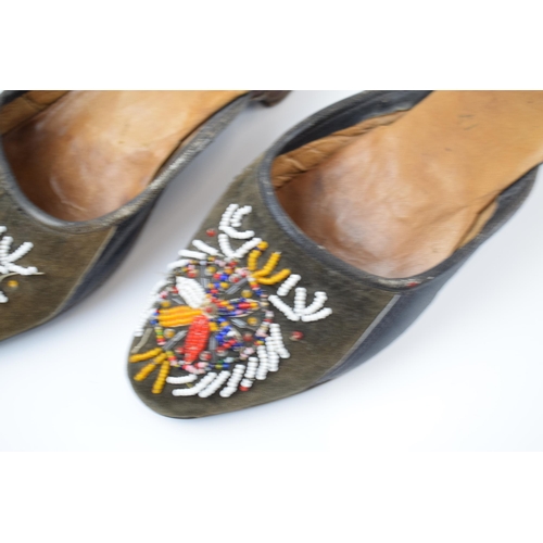 267 - A pair of Russian hand embroidered shoes with overlaid decoration, 25cm long.