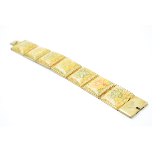 427 - Yellow metal and oriental panel bracelet, 19.5cm long.