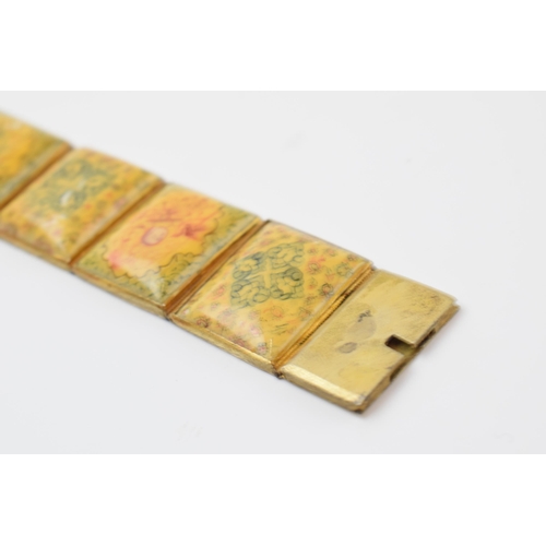 427 - Yellow metal and oriental panel bracelet, 19.5cm long.