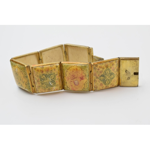 427 - Yellow metal and oriental panel bracelet, 19.5cm long.