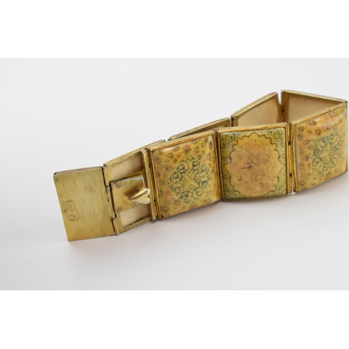 427 - Yellow metal and oriental panel bracelet, 19.5cm long.