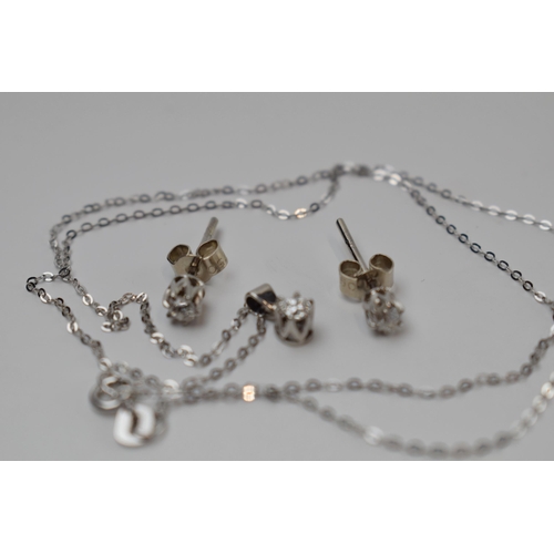 428 - 18ct white diamond dress set including a pendant on chain and a pair of diamond studs.