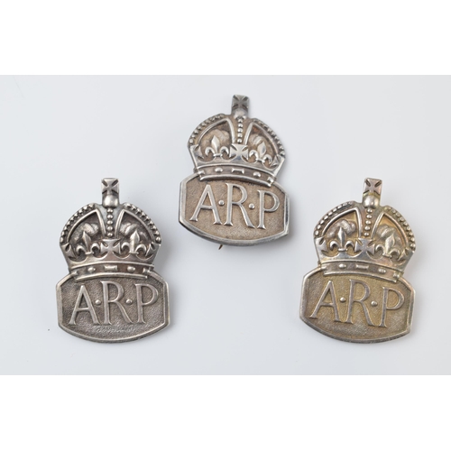 451 - A trio of silver ARP badges, all with London hallmarks (3).