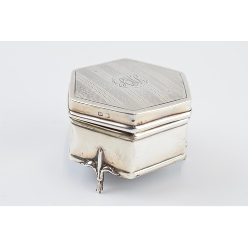 310A - Silver hexagonal trinket box, raised on three feet, with silk interior, Birmingham 1914, 6cm wide.