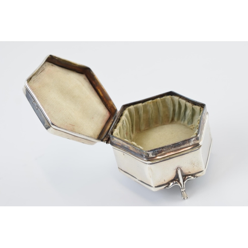 310A - Silver hexagonal trinket box, raised on three feet, with silk interior, Birmingham 1914, 6cm wide.