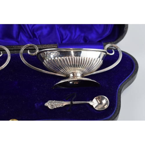 310H - Cased pair of silver salts and spoon, shaped box with velvet lining, gilt interior, Sheffield 1908, ... 