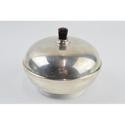 310K - Silver powder puff of domed form, with bakelite interior and handle, Birmingham 1932, gross weight 1... 