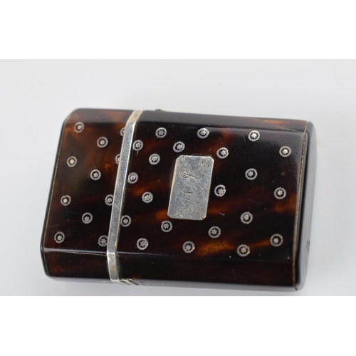 310U - Tortoiseshell box with silver inlaid decoration with hinged lid and compartments, 5.5cm tall.