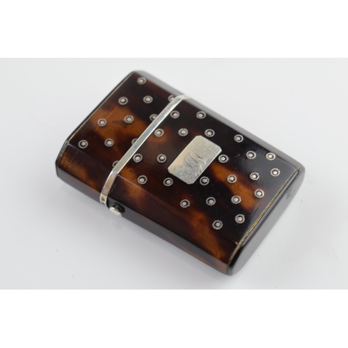 310U - Tortoiseshell box with silver inlaid decoration with hinged lid and compartments, 5.5cm tall.