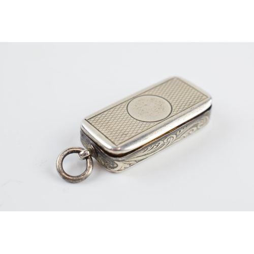 310V - Victorian silver patch box with engraved decoration and vacant cartouche, London 1873, 4cm inc loop.