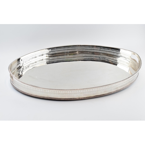 310W - Large Edwardian silver plated oval gallery tray with handles, 61cm wide.