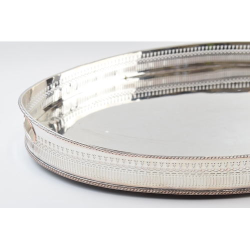 310W - Large Edwardian silver plated oval gallery tray with handles, 61cm wide.