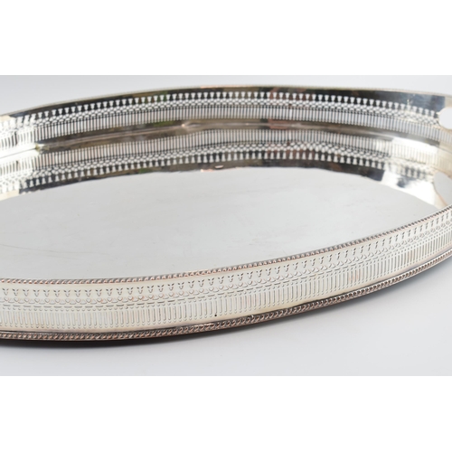 310W - Large Edwardian silver plated oval gallery tray with handles, 61cm wide.